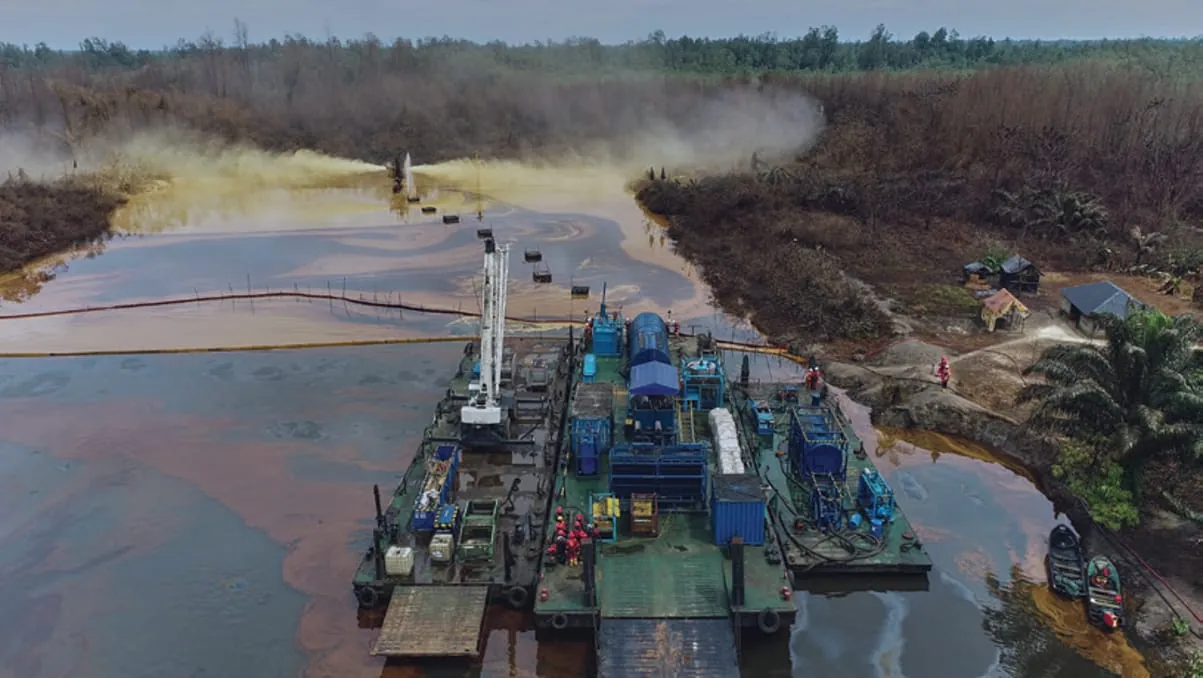 Work barges and crane spread at a riverine well location